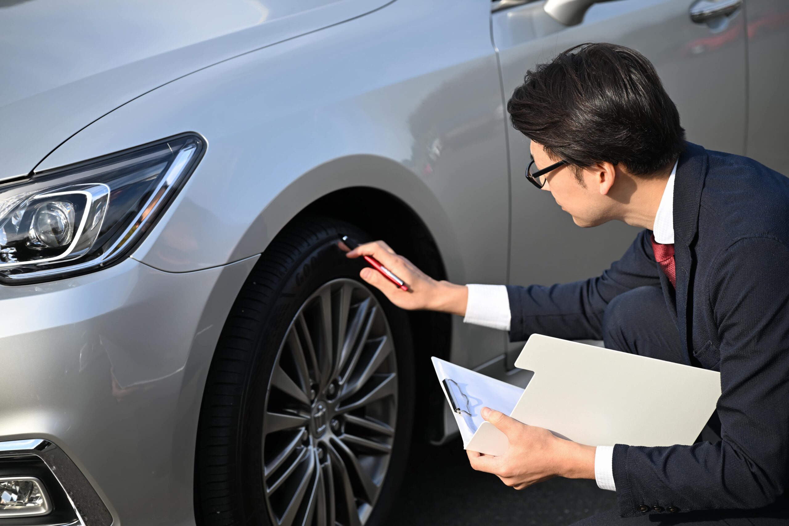 タイヤ周辺を確認する男性